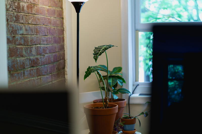 A lamp on a table next to a tv.