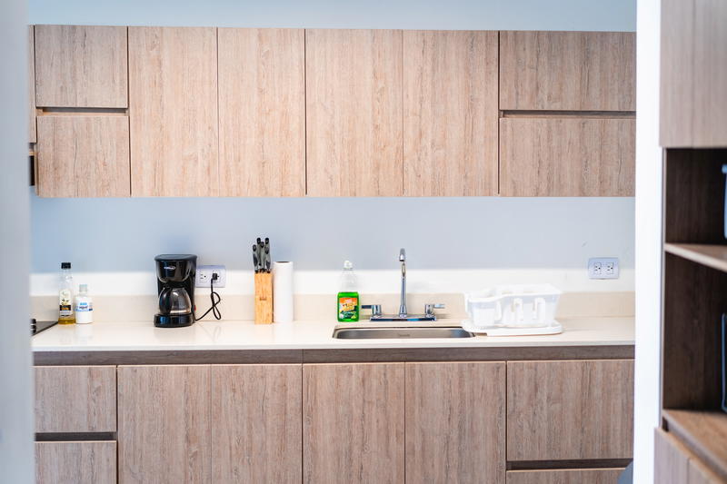 A kitchen with wooden cabinets and a sink.