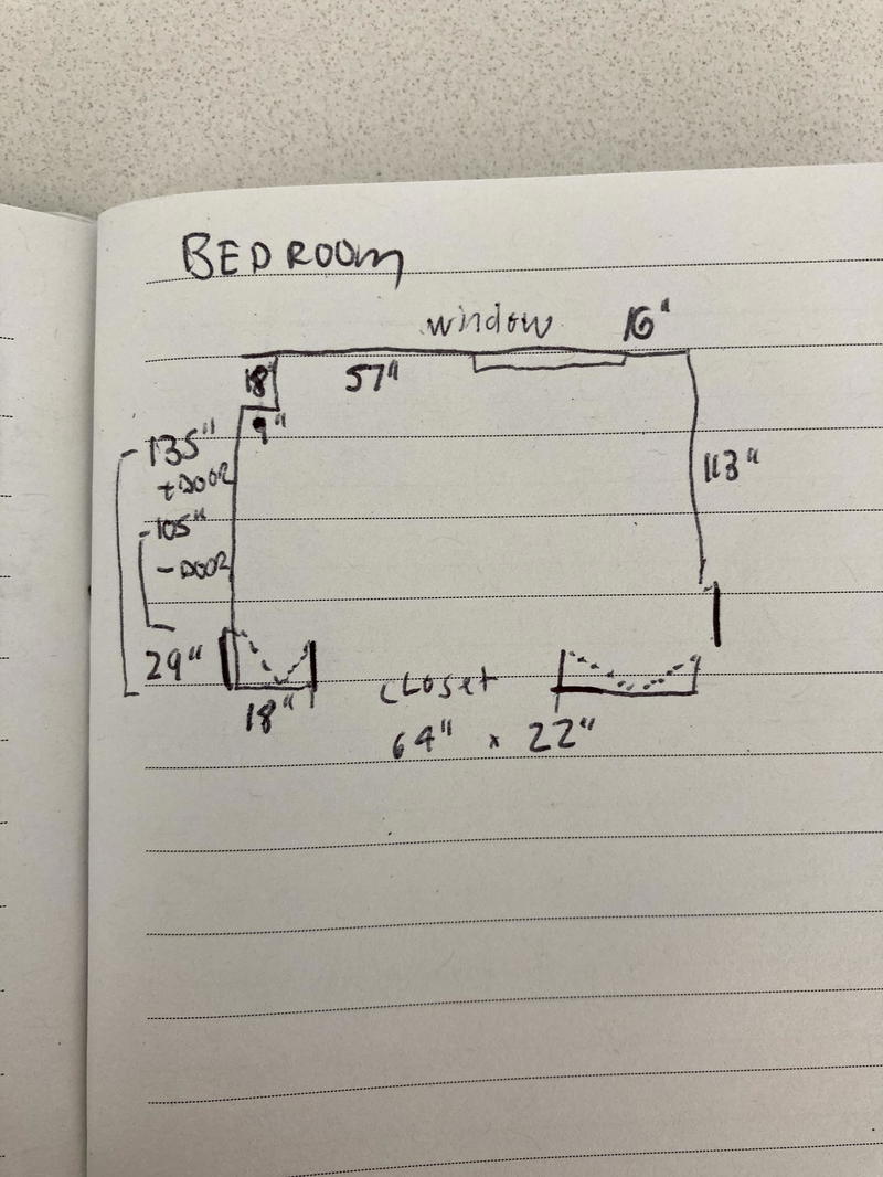 Hand drawn floor plan on a small notebook
