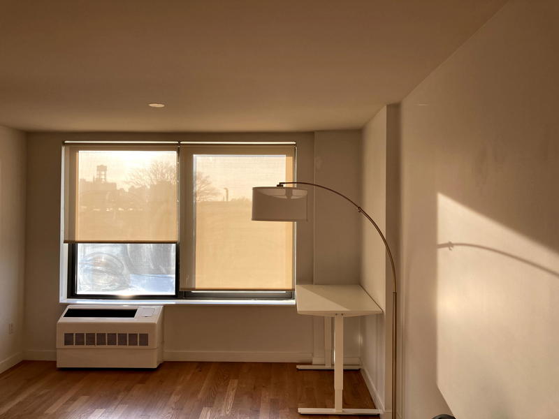 New apartment with only a white desk and lamp