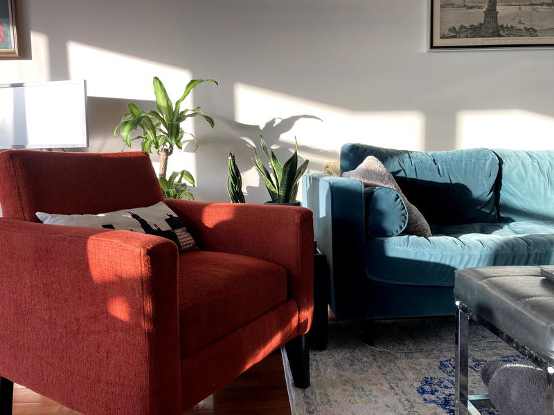 A living room with a couch and a chair.