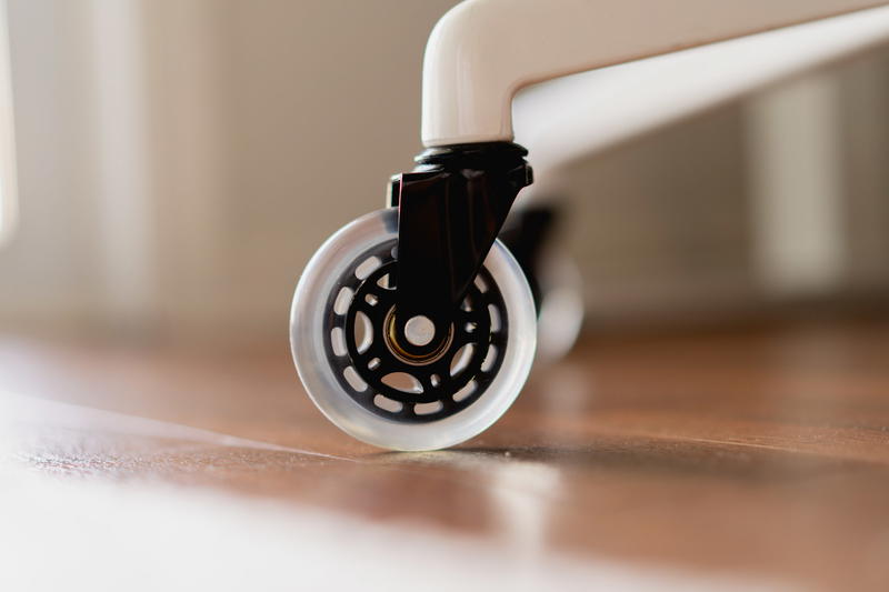 A close up of a rollerblade style desk chair wheel.