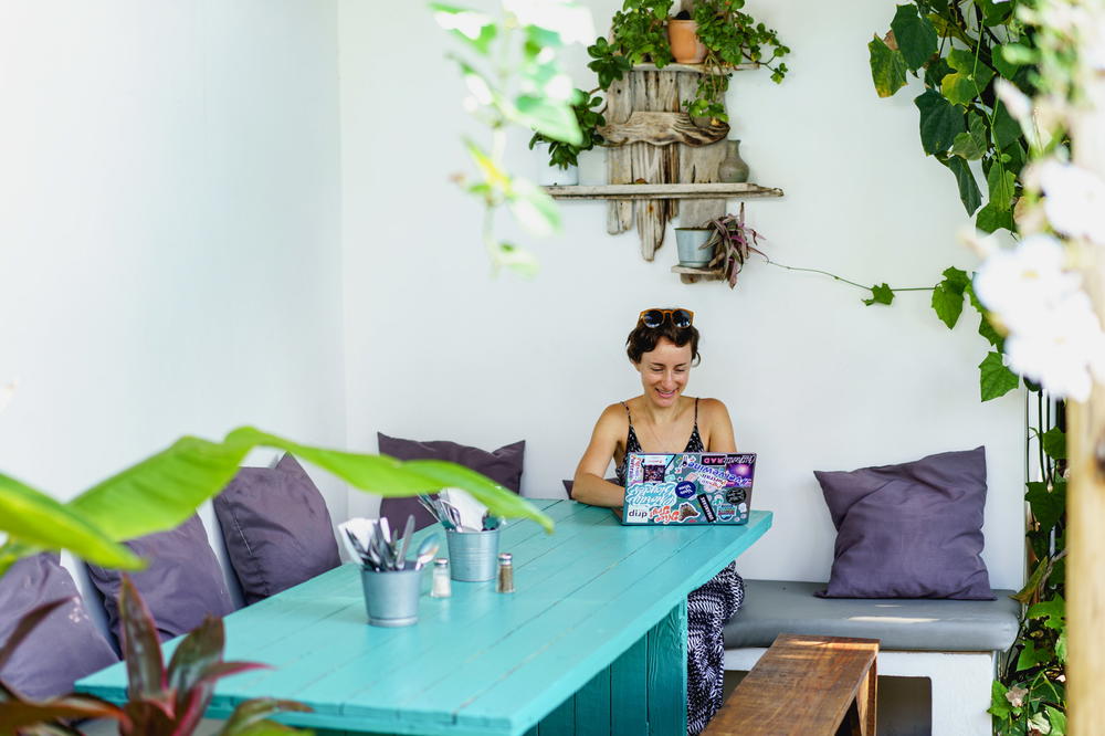 Woman using Dell XPS on a team table outside at a cafe